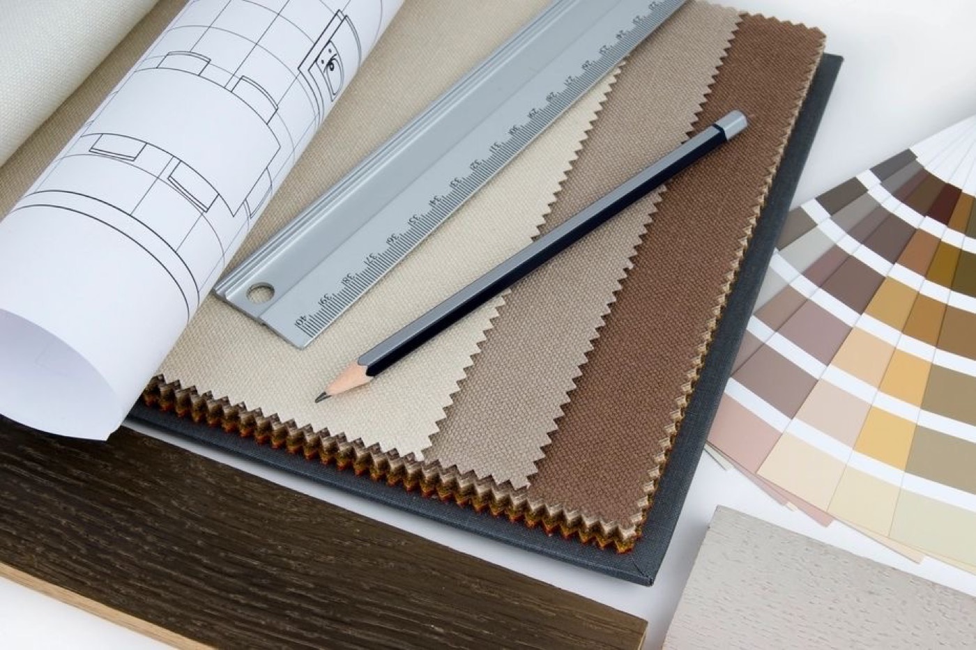 Drawings, a scale rule and material samples on a desk